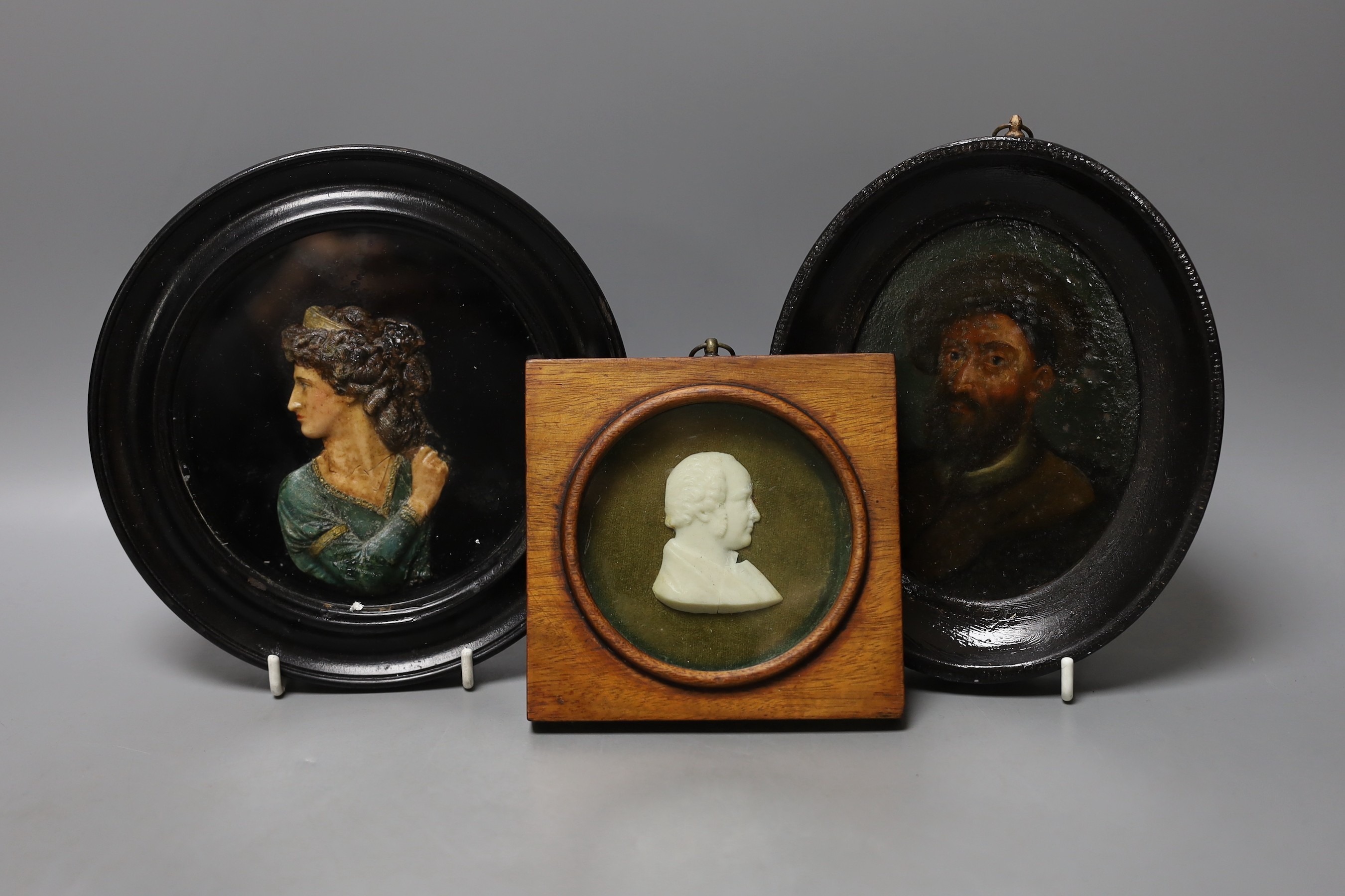 Two framed carved wax portrait busts and an oval miniature